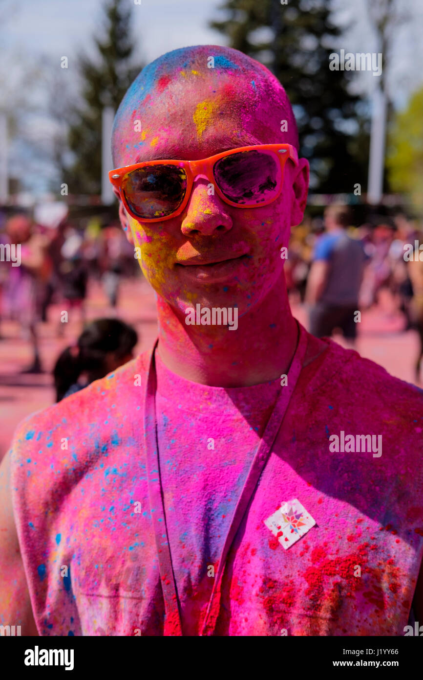 London, Ontario, Canada, 22nd Apr, 2017. Male oriental teenager covered in colourful powder at Victoria Park during the Holi Spring Festival, also known as Rangwali Holi, Dhuleti, Dhulandi, Phagwah, or simply as Festival of Colours, an Hindu festival to celebrate the arrival of Spring in London, Ontario, Canada. Credit: Rubens Alarcon/Alamy Live News. Stock Photo