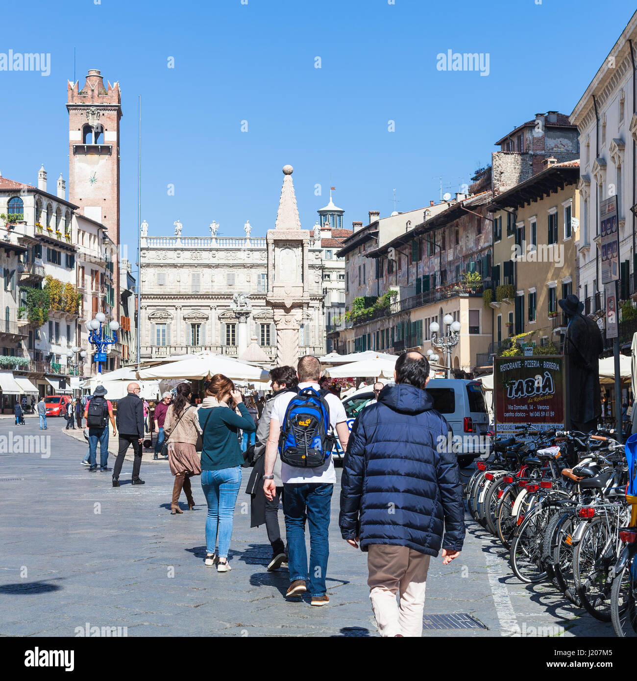 VERONA, ITALY - MARCH 29, 2017: tourists on Piazza delle Erbe (Market's square) in Verona in spring. Verona is city on the Adige river, one of the sev Stock Photo