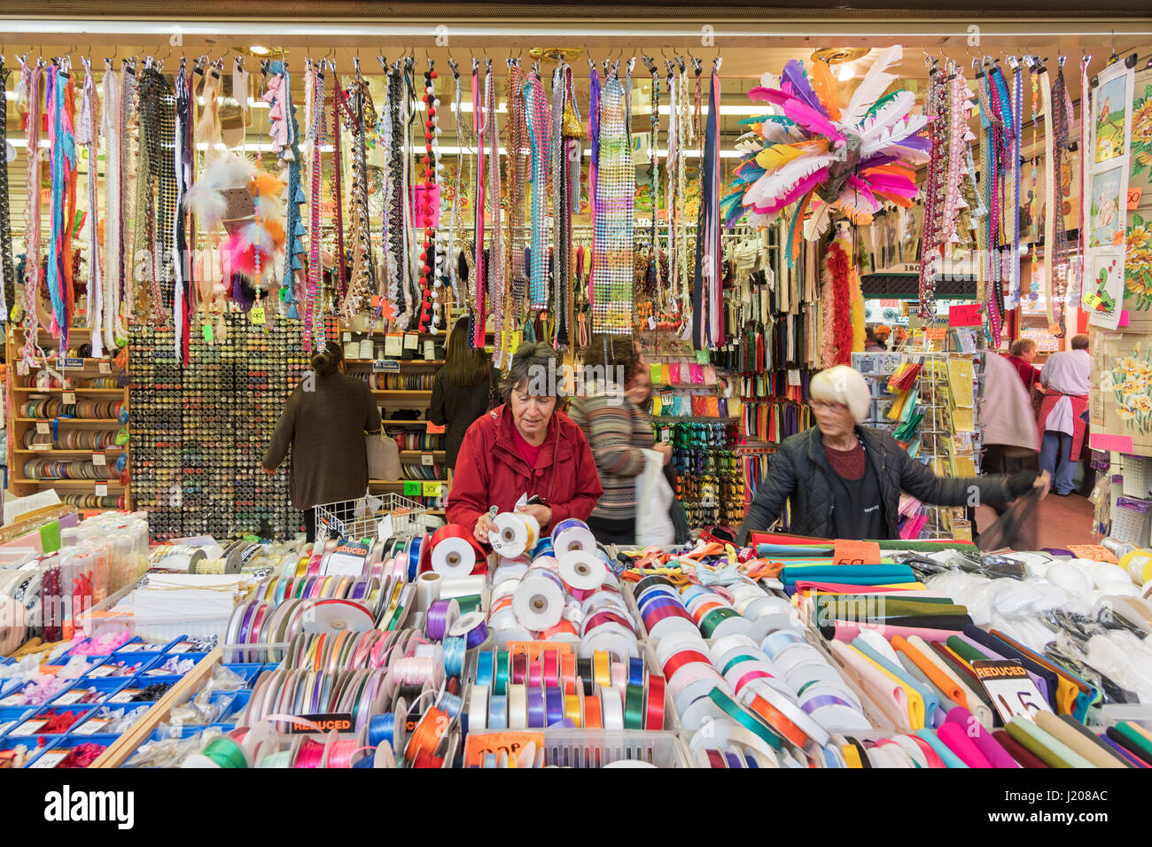 Woman shopping at haberdashery stall, Grainger Market, Newcastle upon Tyne, England, UK Stock Photo