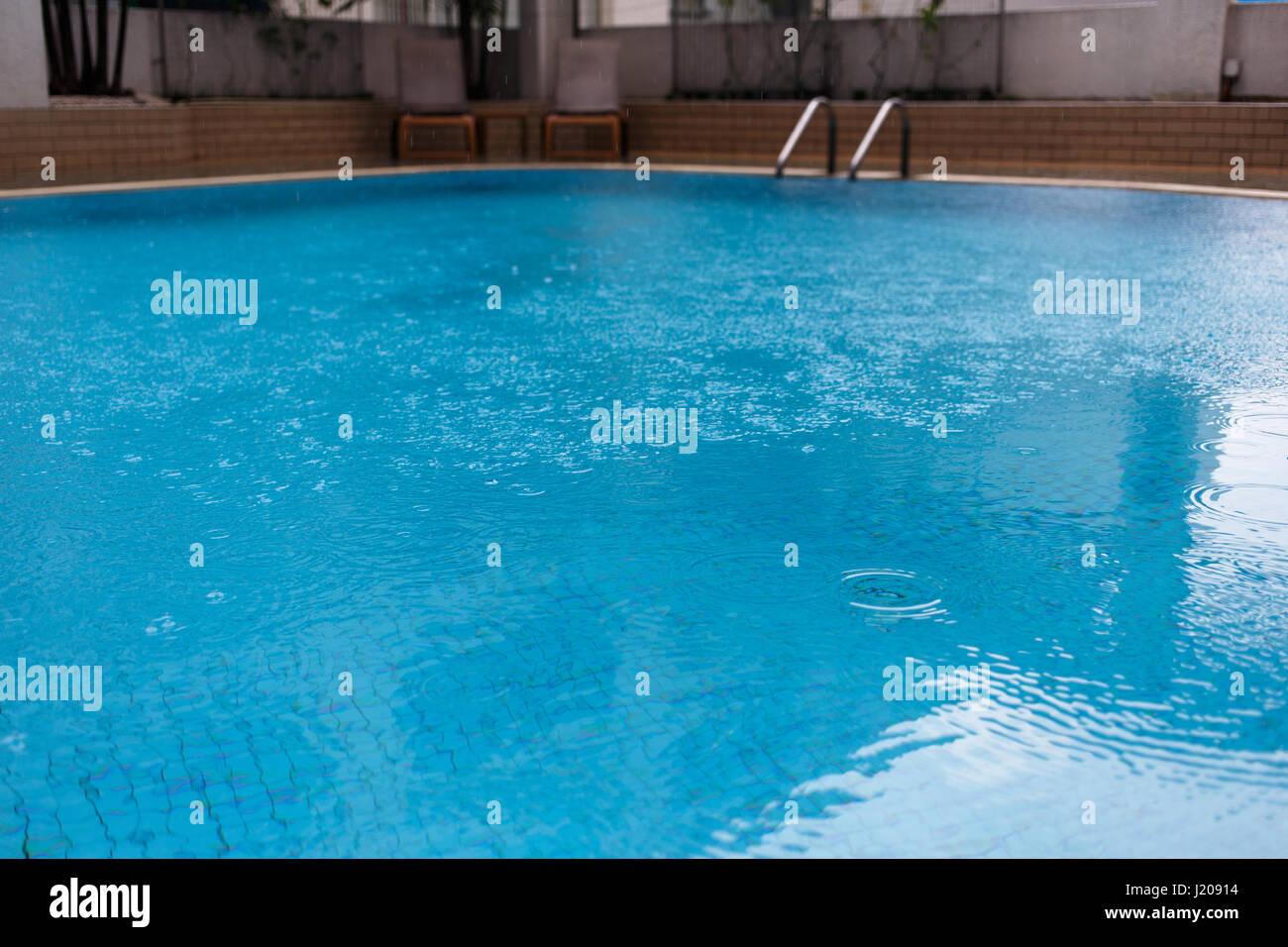 Swimming pool with ladder , chairs Stock Photo Alamy