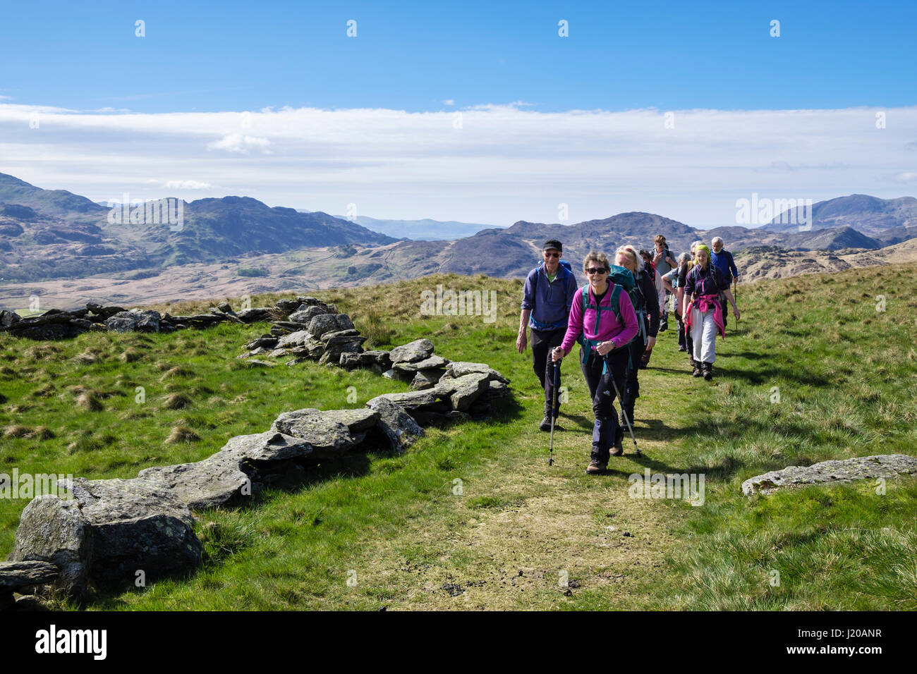 Hikers hiking on old miners track to Y Lliwedd mountain in Snowdonia National Park. Gwynedd, Wales, UK, Britain, Europe Stock Photo