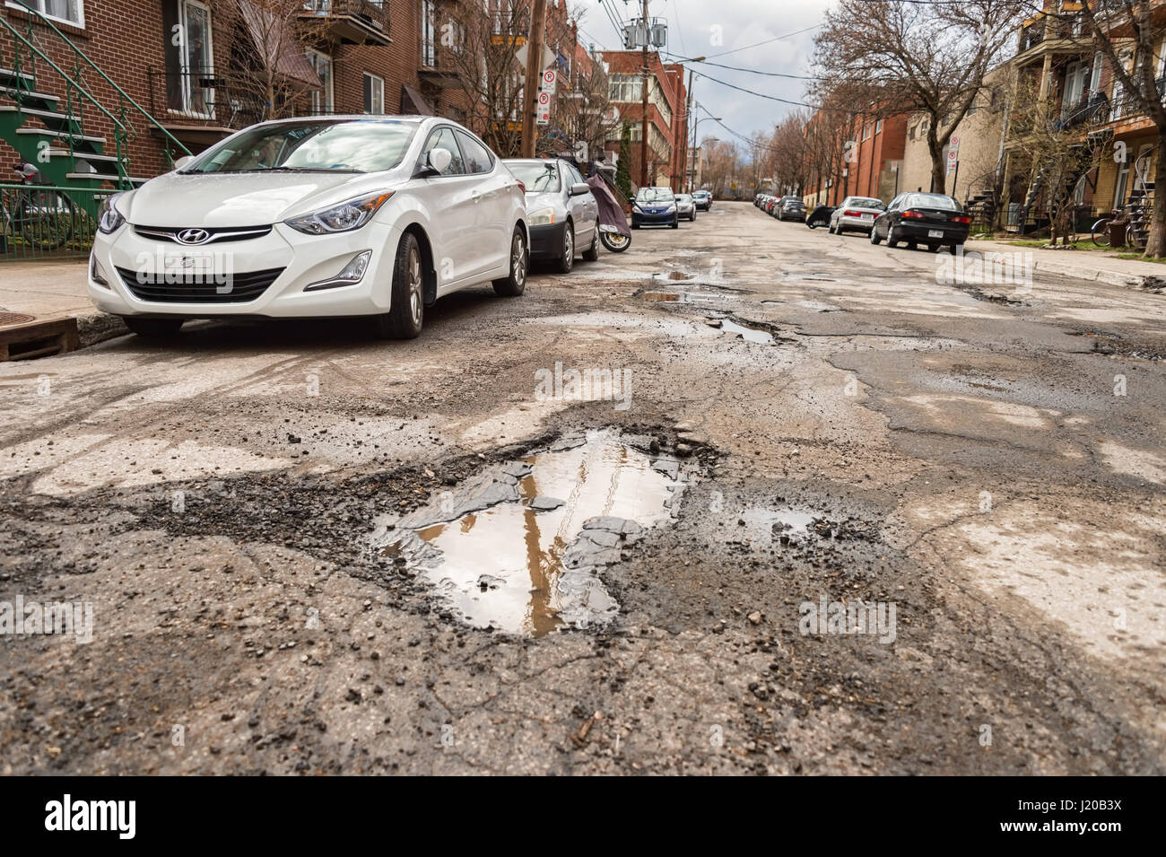 Montreal, Canada - 21 April 2017: Large unrepaired potholes on Chabot street Stock Photo