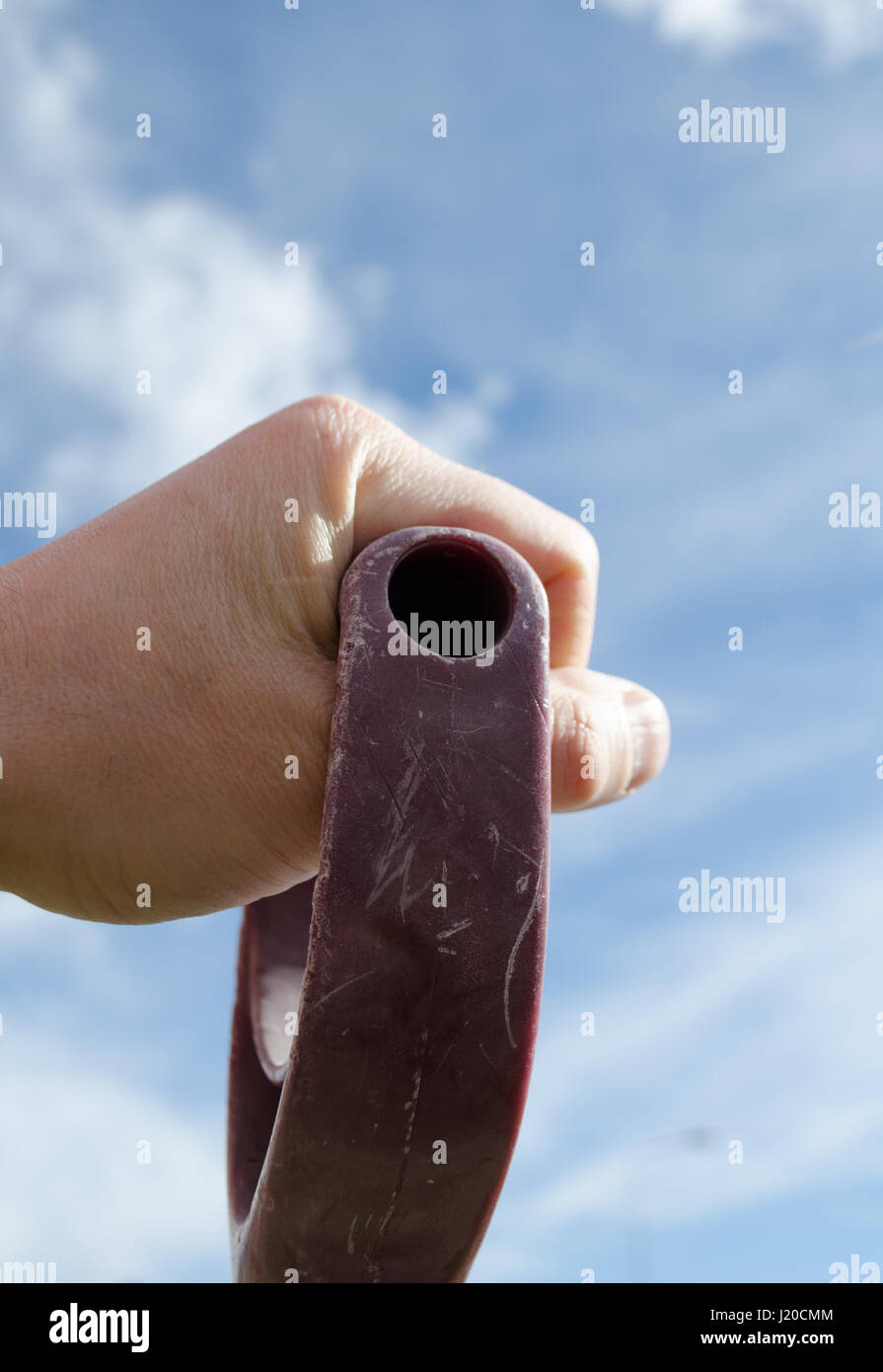 Hand holding shovel against ble sky Stock Photo Alamy