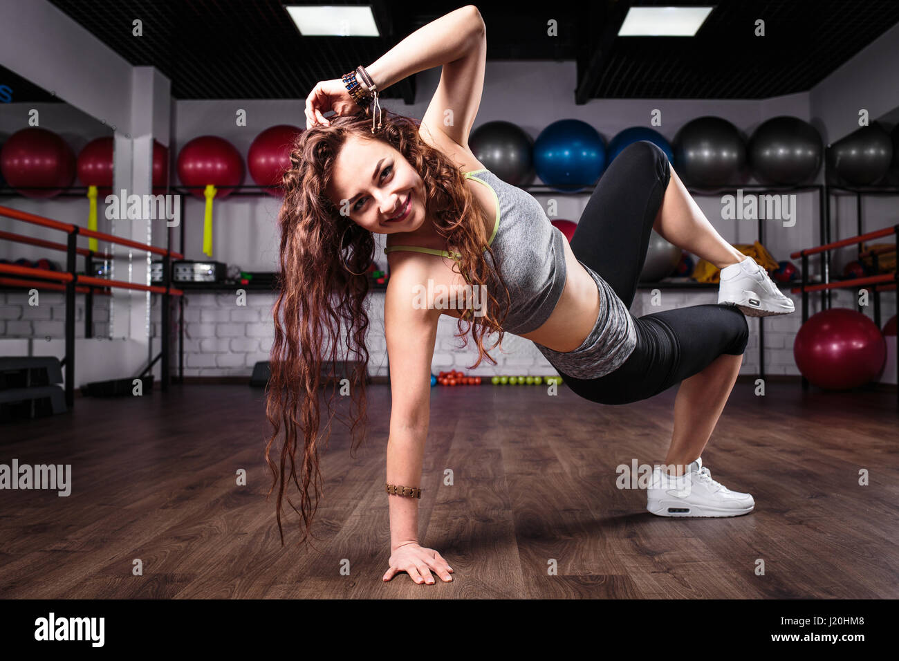 Fitness girl dancing zumba workout in gym. Weight loss activity