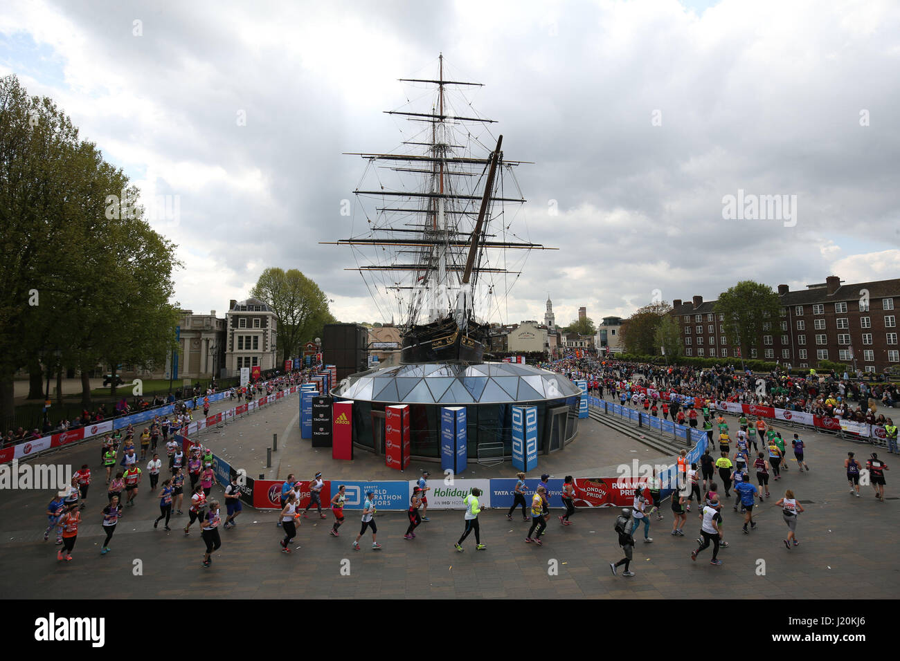 Runners make their way around the Cutty Sark during the Virgin Money London Marathon, London. Stock Photo