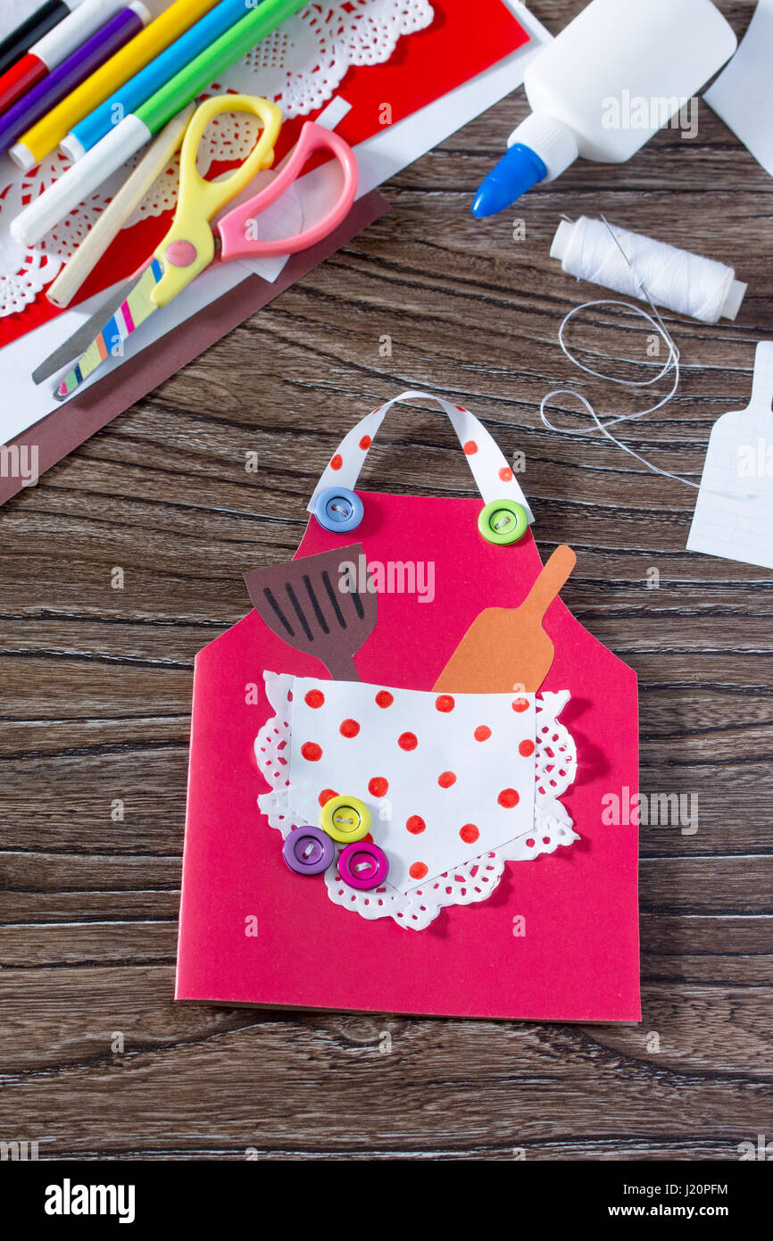 Creates a baby gift from a paper apron postcard for grandmother on mother's  day. Hand-made. The project of children's creativity, needlework, crafts  Stock Photo - Alamy