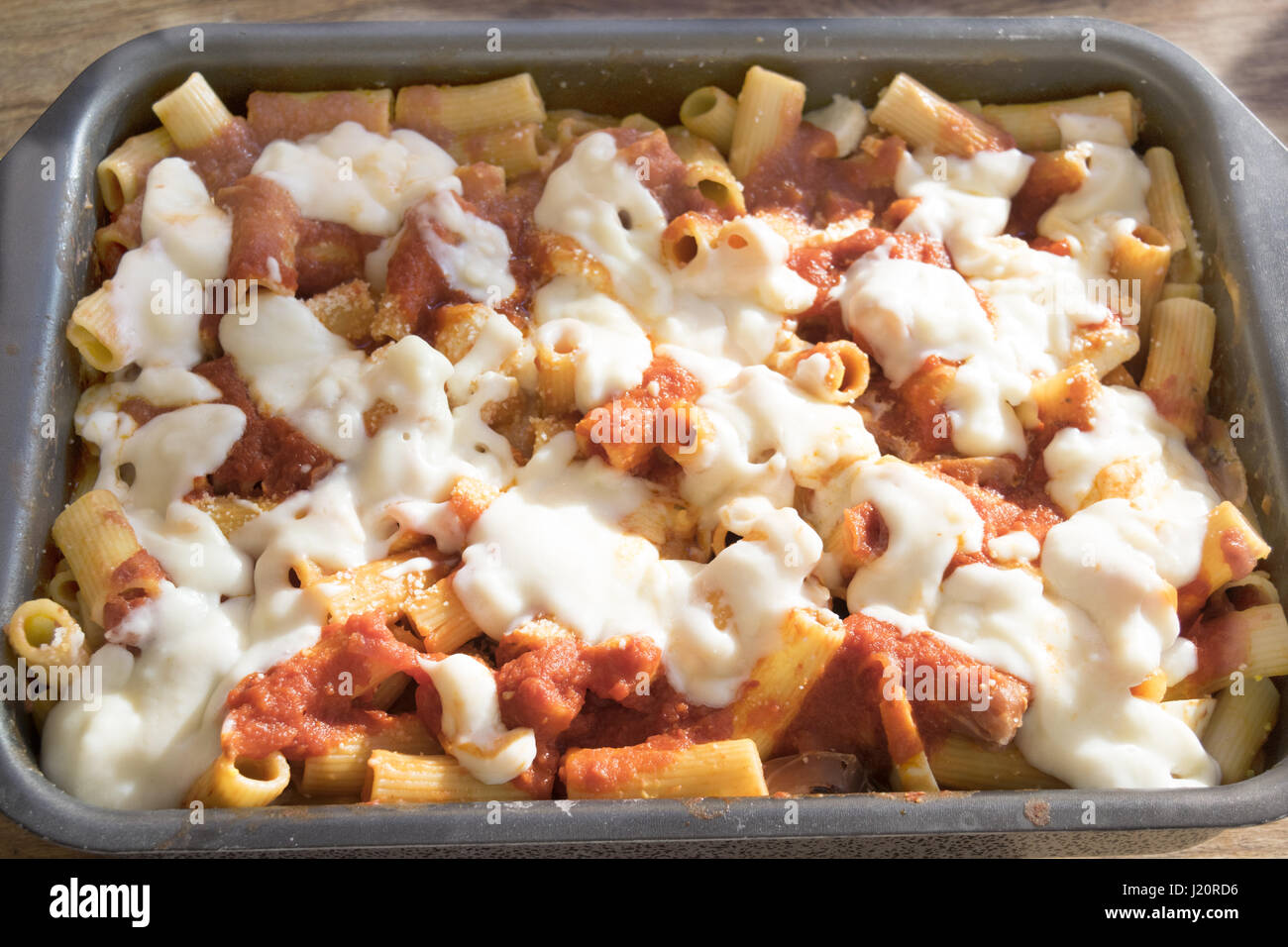 baking tray of baked pasta with mozzarella Stock Photo