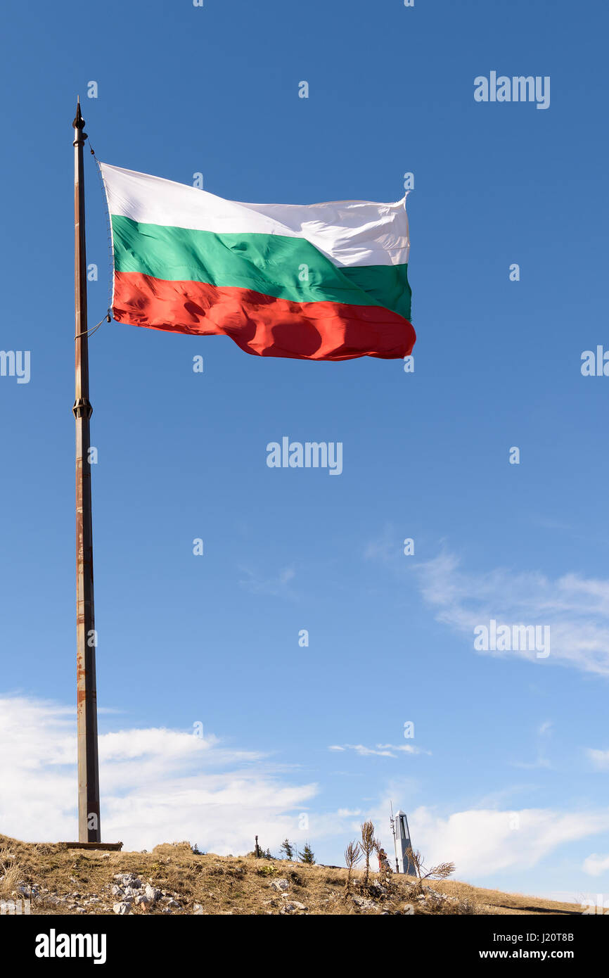 National flag of Bulgaria on metal pole against blue sky Stock Photo