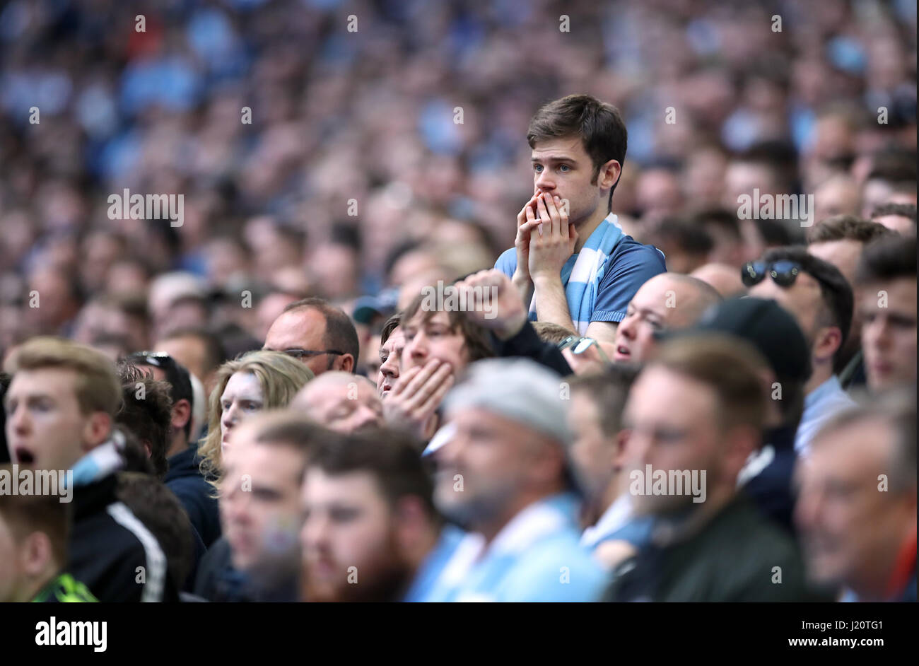 Manchester City fans show dejection in the stands after their side concede during extras time of the Emirates FA Cup, Semi Final match at Wembley Stadium, London. PRESS ASSOCIATION Photo. Picture date: Sunday April 23, 2017. See PA story SOCCER Arsenal. Photo credit should read: Nick Potts/PA Wire. RESTRICTIONS: No use with unauthorised audio, video, data, fixture lists, club/league logos or 'live' services. Online in-match use limited to 75 images, no video emulation. No use in betting, games or single club/league/player publications. Stock Photo