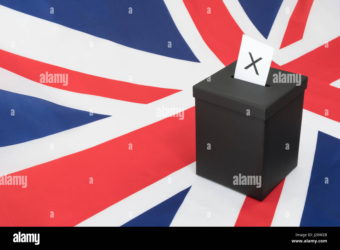 Replica black ballot box set against UK flag / Union Jack as metaphor for concept of British 2024 General Election - Brexit Election, Mock election. Stock Photo