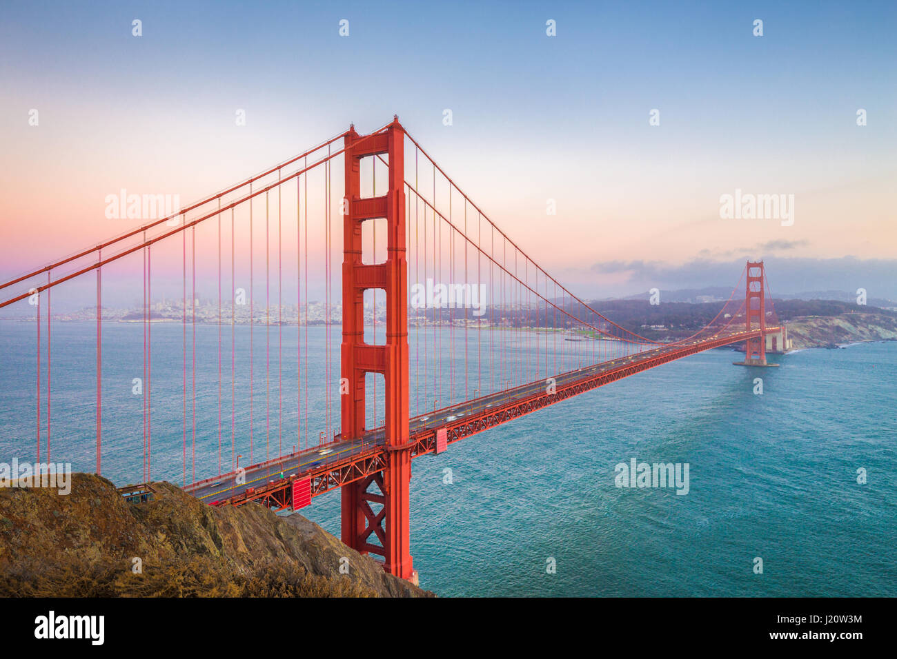 Classic panoramic view of famous Golden Gate Bridge seen from Battery Spencer viewpoint in beautiful post sunset twilight during blue hour at dusk in  Stock Photo