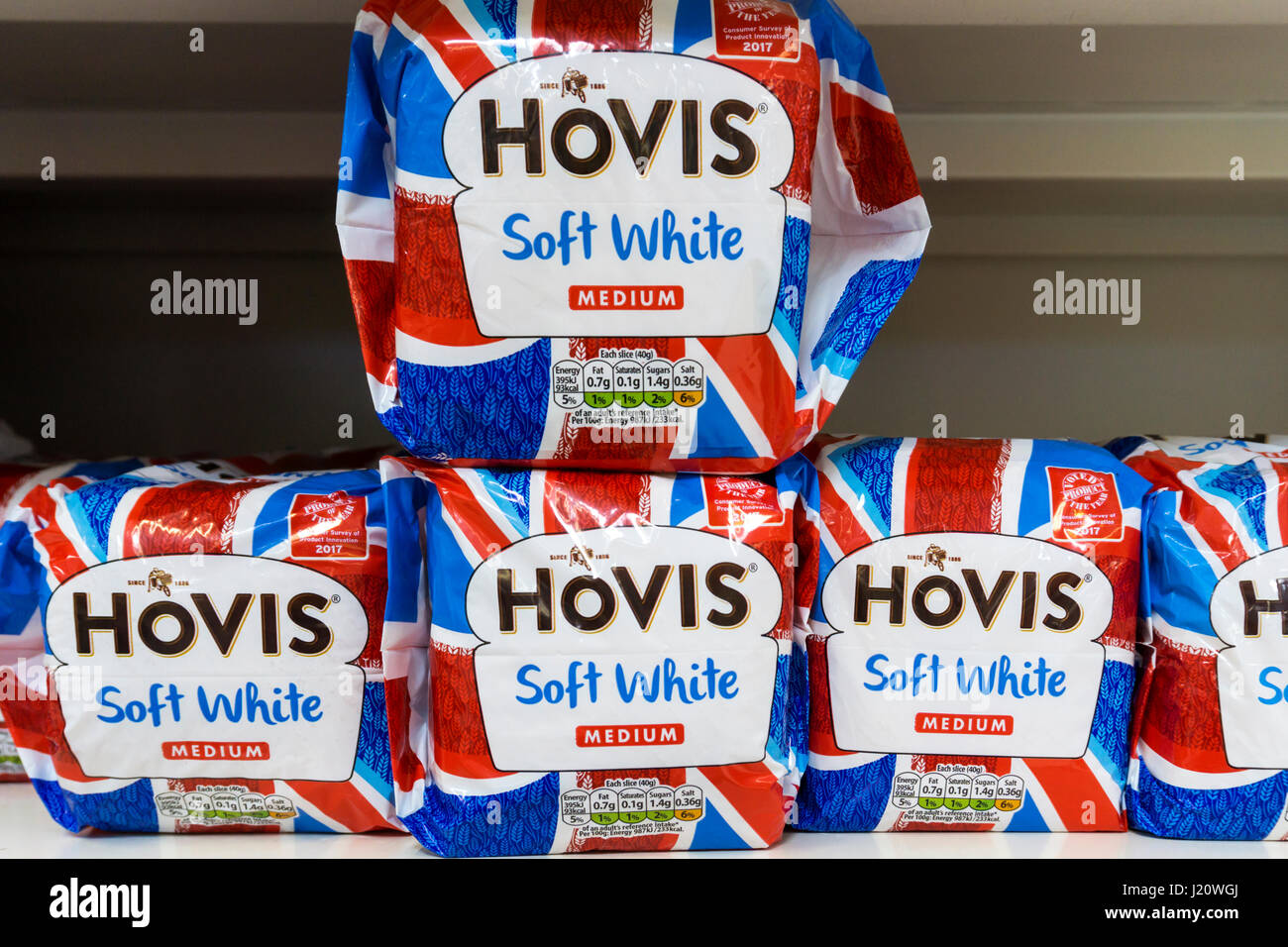 Loaves of Hovis Medium Sliced Soft White bread for sale on a supermarket shelf, in Union Jack themed wrapping. Stock Photo
