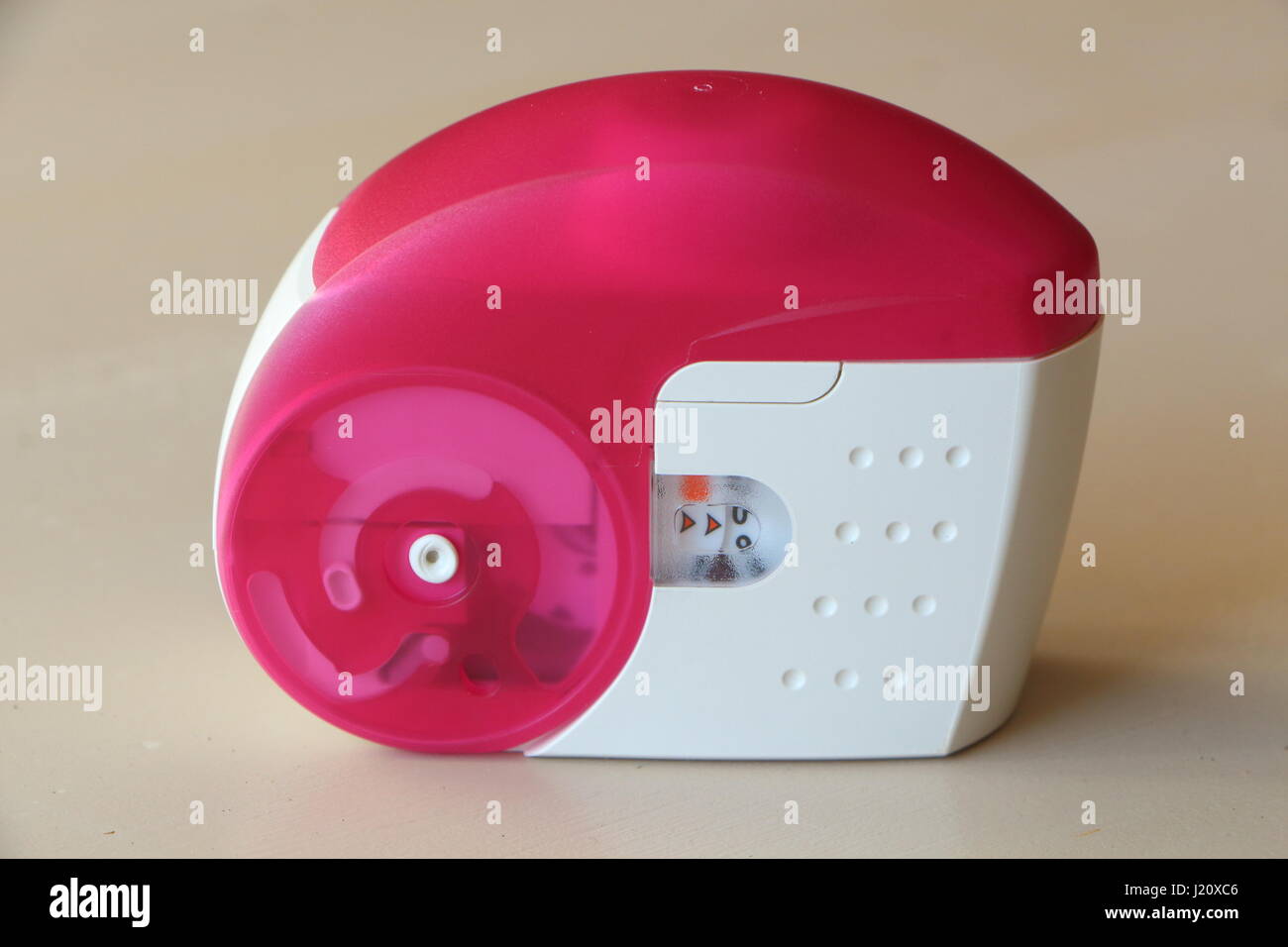 Pink and white inhaler against asthma Stock Photo