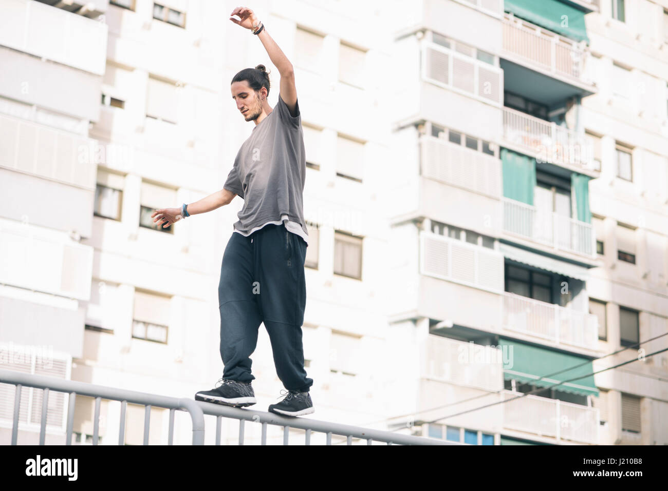 Balancing On Railing Young man balancing on railing hi-res stock photography and images - Alamy