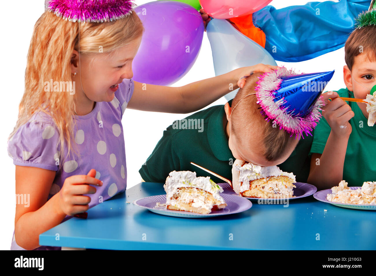 Birthday children celebrate party and eating cake on plate together
