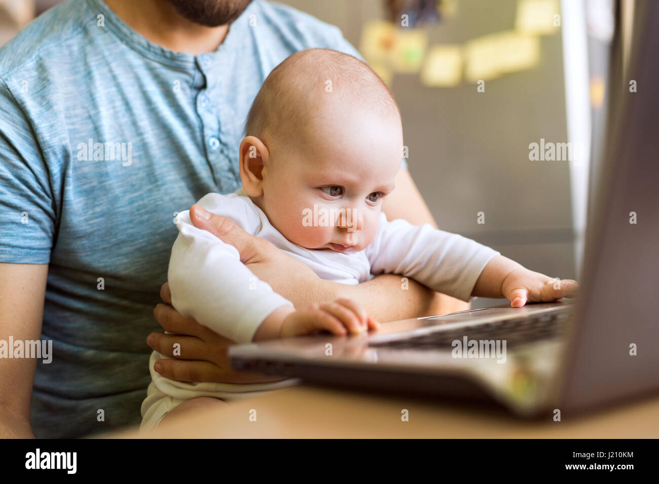 Father with baby son using laptop at home Stock Photo - Alamy