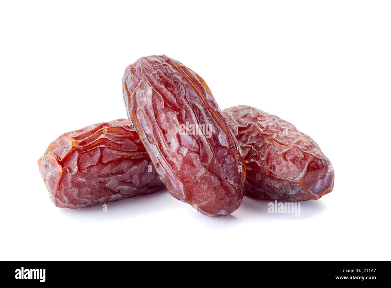 Three dried date-fruit on white Stock Photo