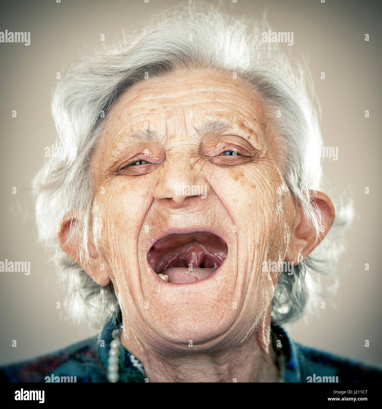 portrait-of-an-elderly-lady-laughing-out-loud-J211C7.jpg