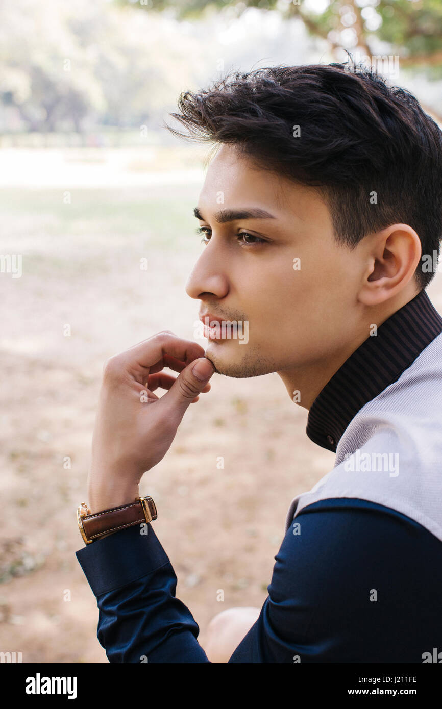 Fashionable tall arab beard man wear on shirt, jeans and sunglasses posed  on park and hold wallet at hand. 10490636 Stock Photo at Vecteezy