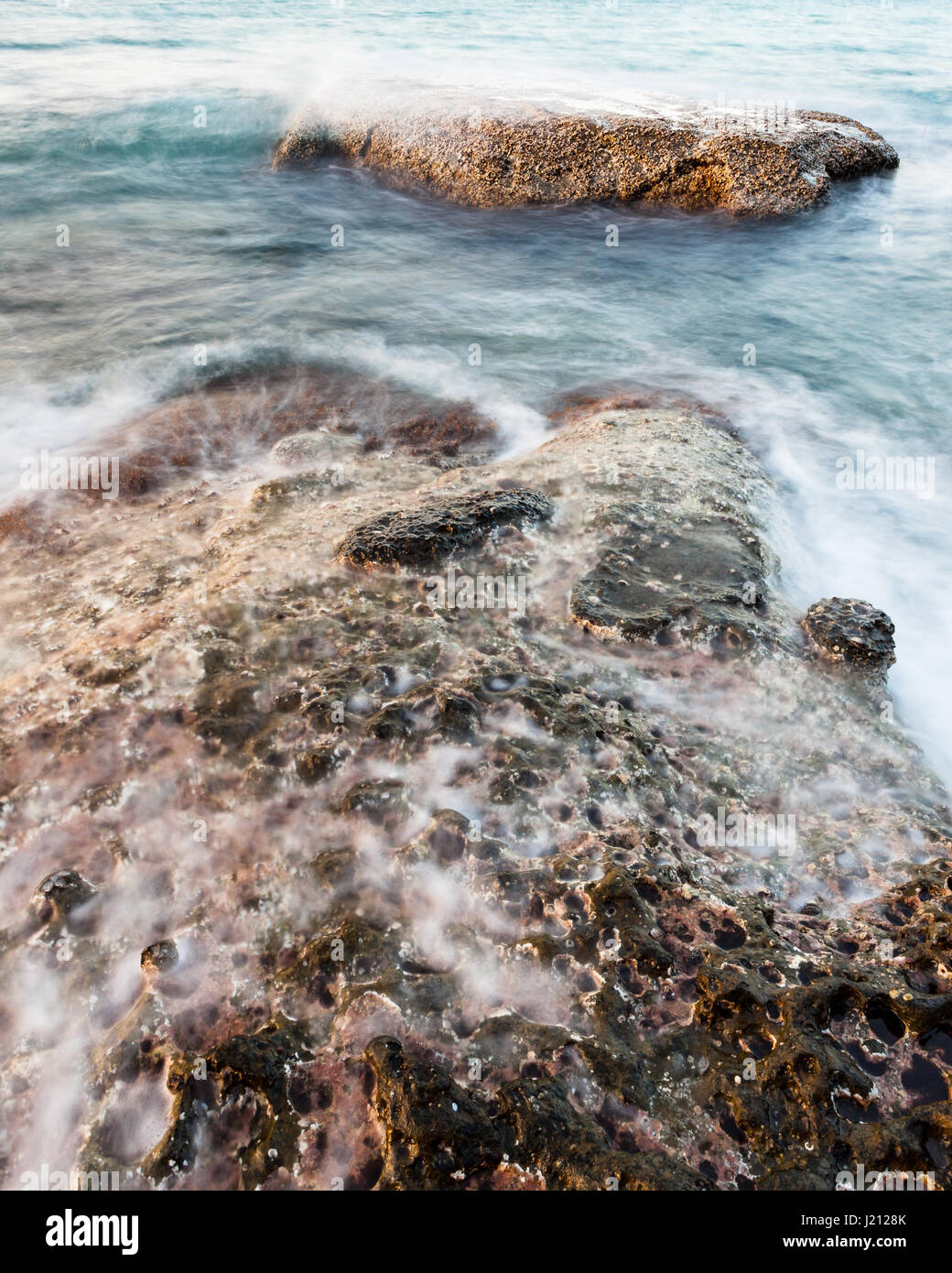 Waves and rocks shore long exposure Stock Photo - Alamy