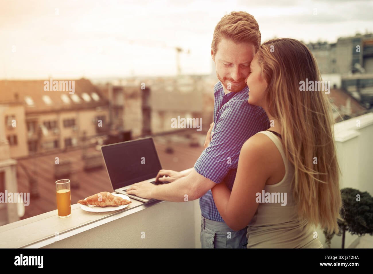 Couple in love hugging outdoors in top of building Stock Photo - Alamy