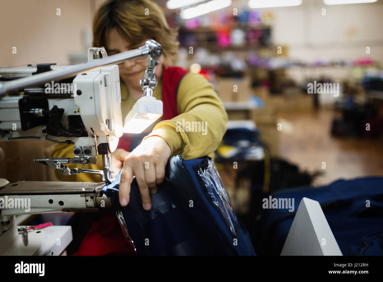 Woman working in sewing industry on machine Stock Photo
