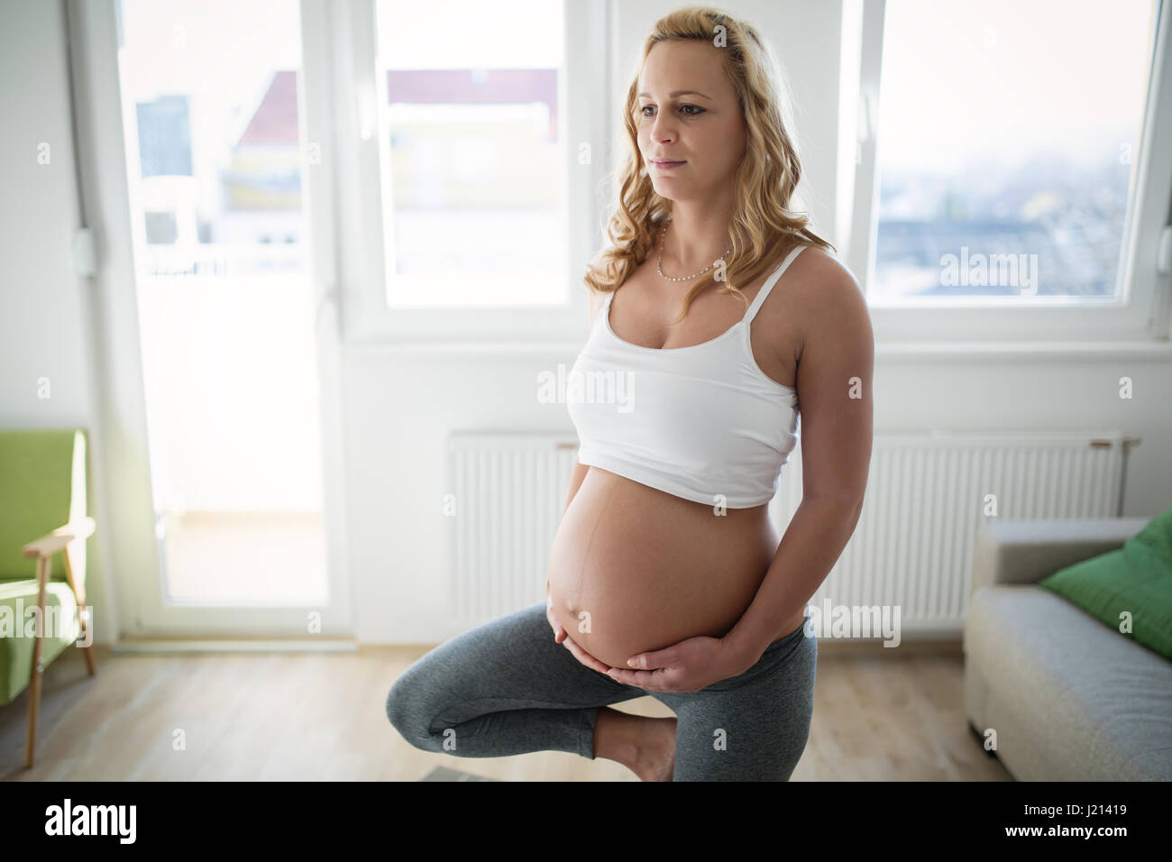 Combating lack of energy during pregnancy with fitness workout Stock Photo