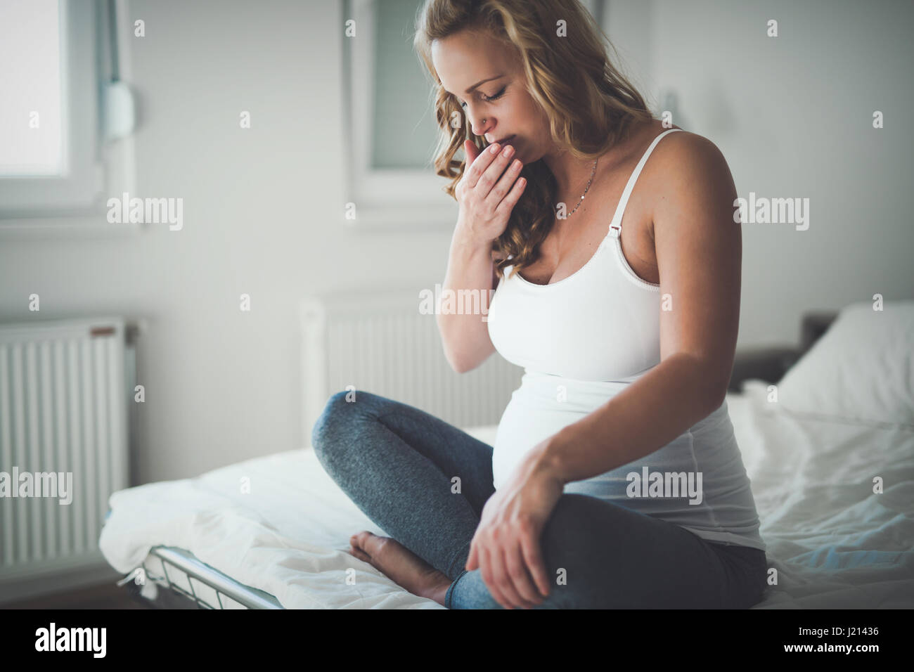 Beautiful expectant pregnant woman suffering from nausea Stock Photo