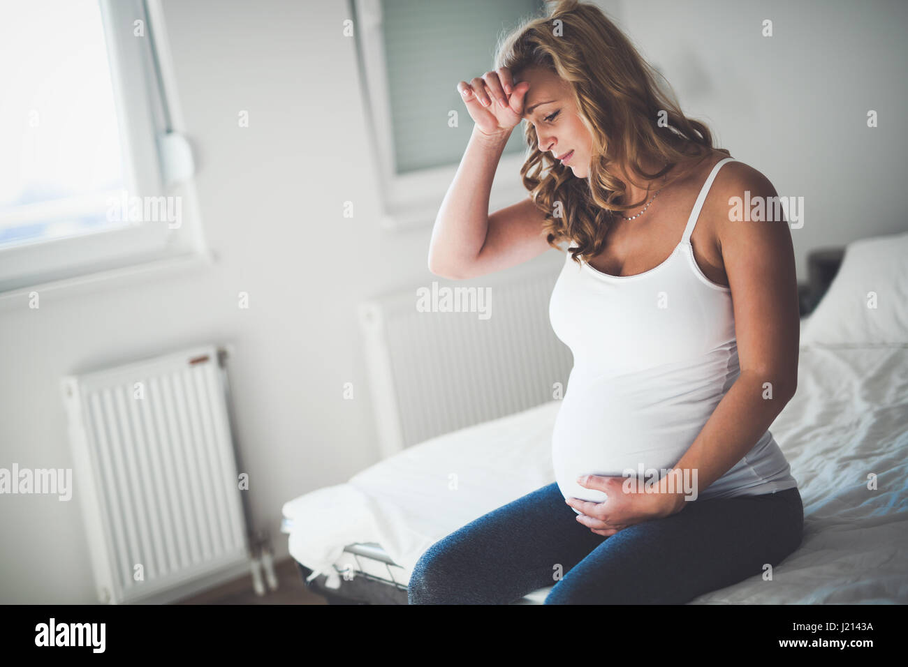 Beautiful expectant pregnant woman suffering from nausea Stock Photo