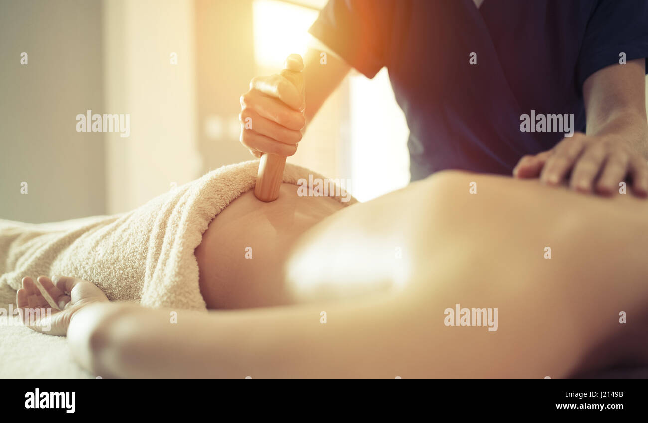 Masseur treating patient with therapeutic massage treatment Stock Photo