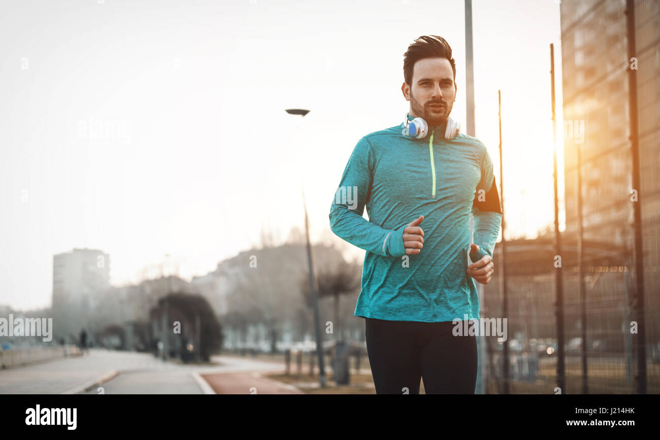 Handsome runner exercising by running and jogging  in city Stock Photo