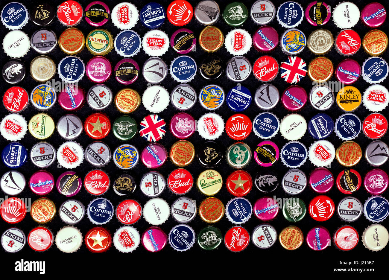 SOUTHAMPTON, UK - 21 Jan 2017: A background of bottle caps from a variety of popular beers, lagers and ciders from around the world. Stock Photo