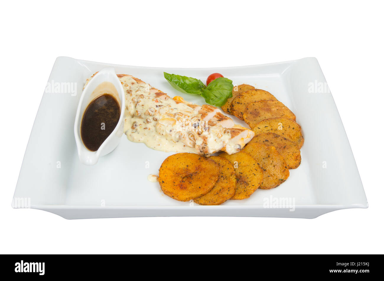 Portion of roast fillet of white chicken with mushroom sauce and roasted potatoes. Stock Photo