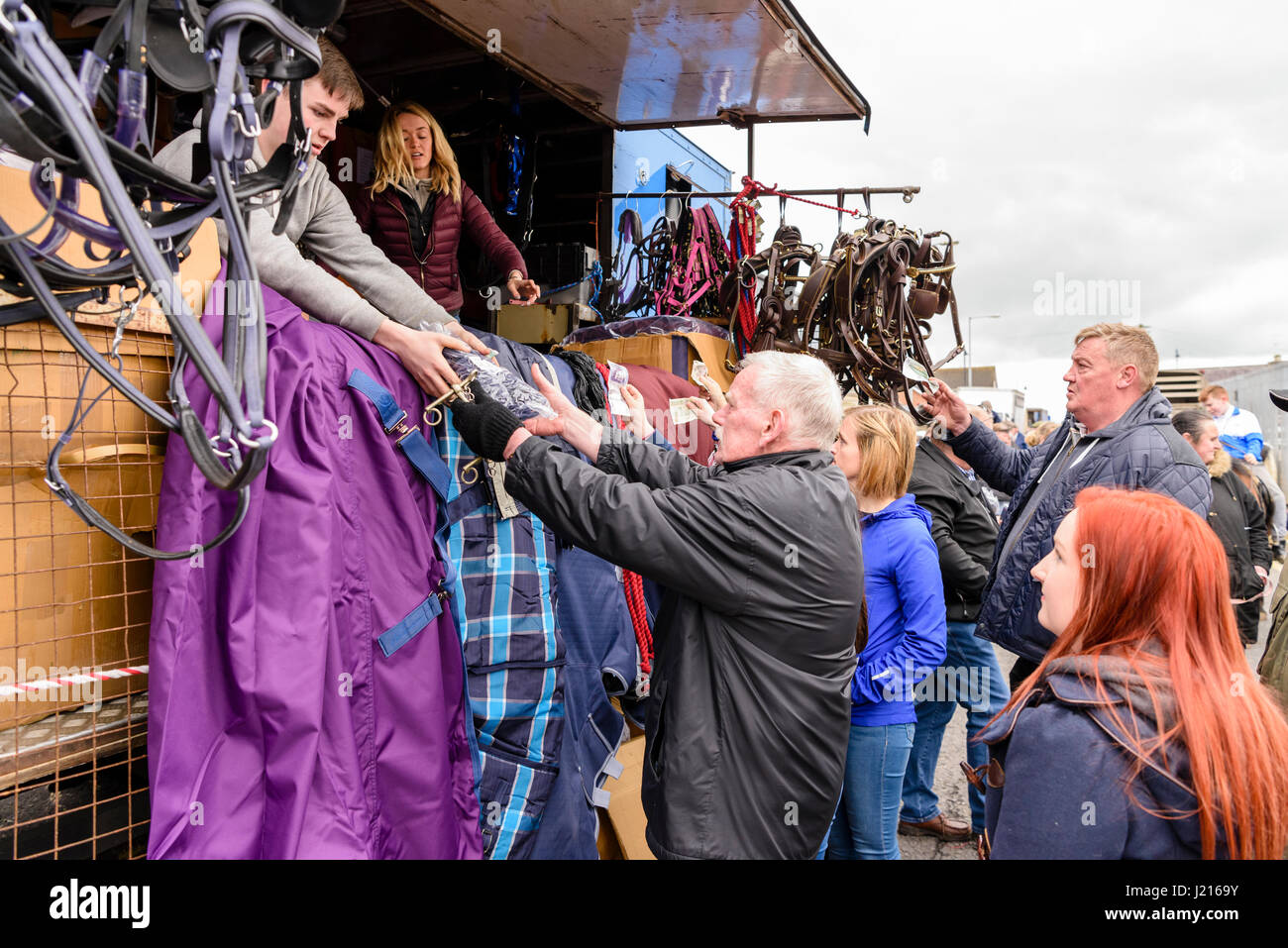 Customers hand over money at an auction for horse equipment at the Toome Horse Fair, Northern Ireland Stock Photo