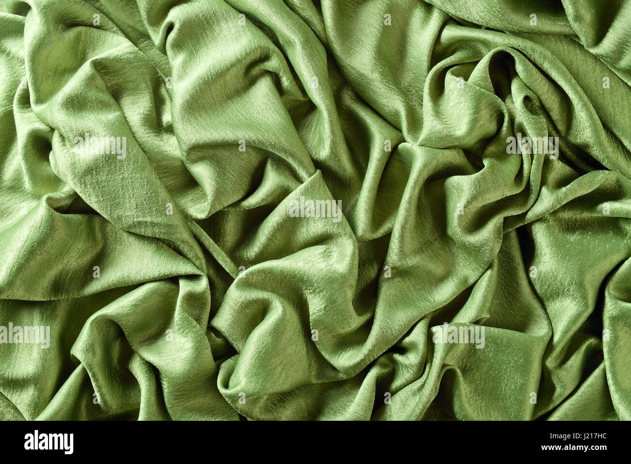 Smooth elegant green satin or silk .Cloth texture can use as background ...