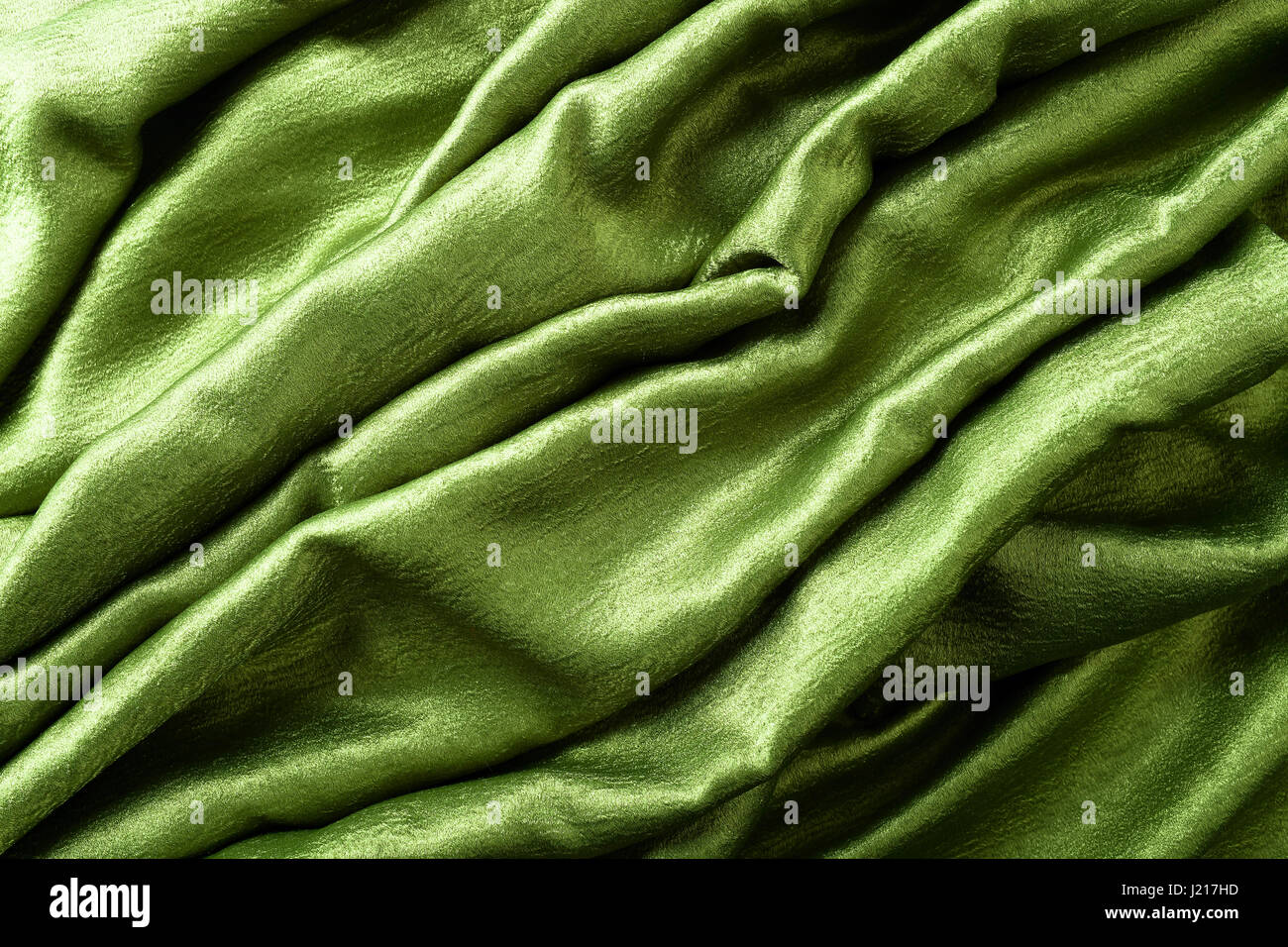 Smooth elegant green satin or silk .Cloth texture can use as background ...