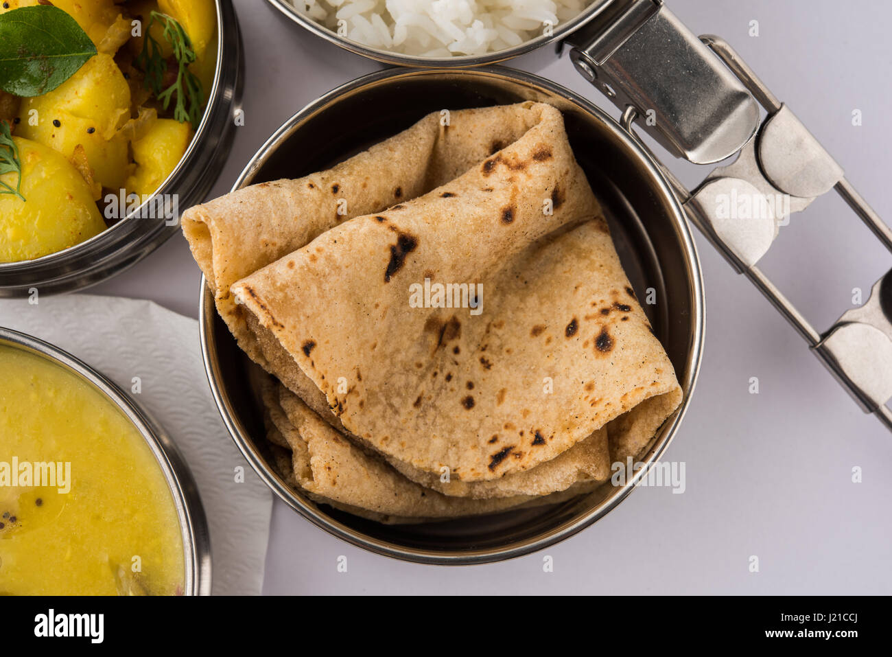 indian typical stainless steel lunch box or tiffin with north indian or