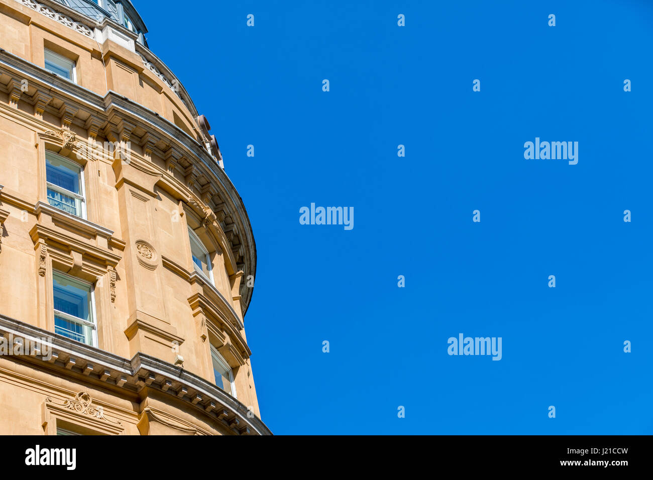an elaborate building as seen from below against a brilliant blue sky, London, England, UK Stock Photo
