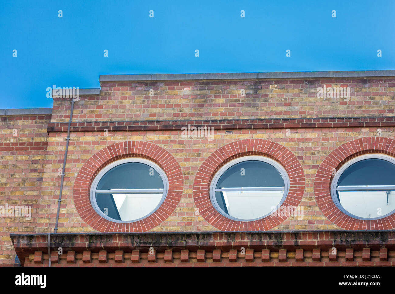 three round windows in a building in London, London, England, UK Stock Photo