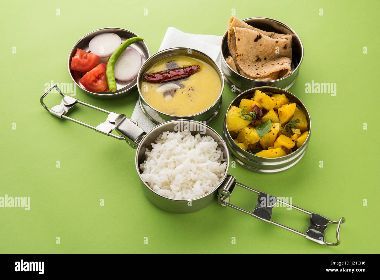 indian typical stainless steel lunch box or tiffin with north indian or maharashtrian food menu