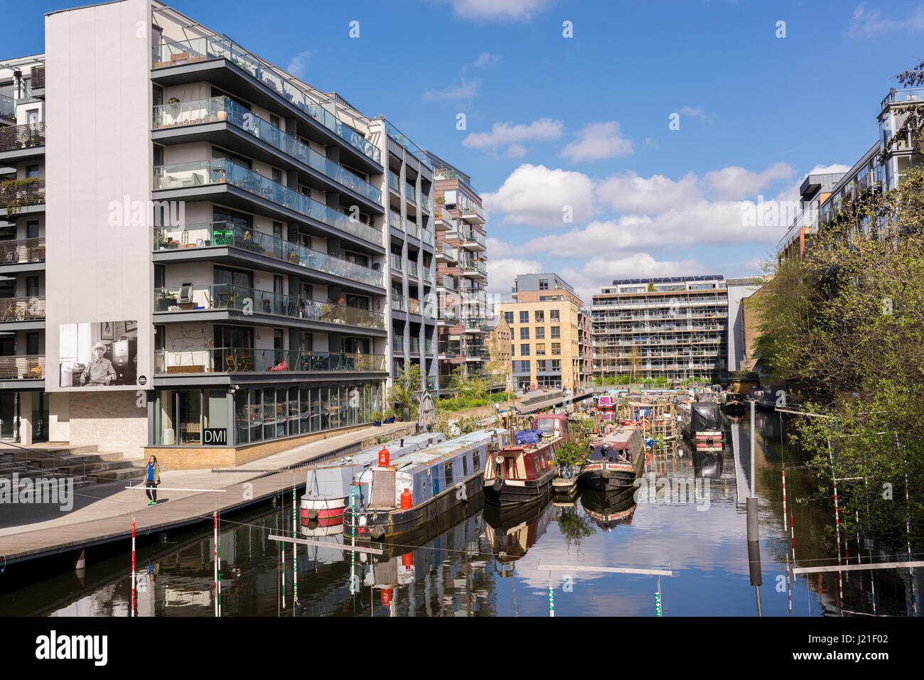 Modern apartments next to a boat house mooring dock in Haggerston, Hackney, East London. Known as the Haggerston Riviera and lined with cafes and arts Stock Photo