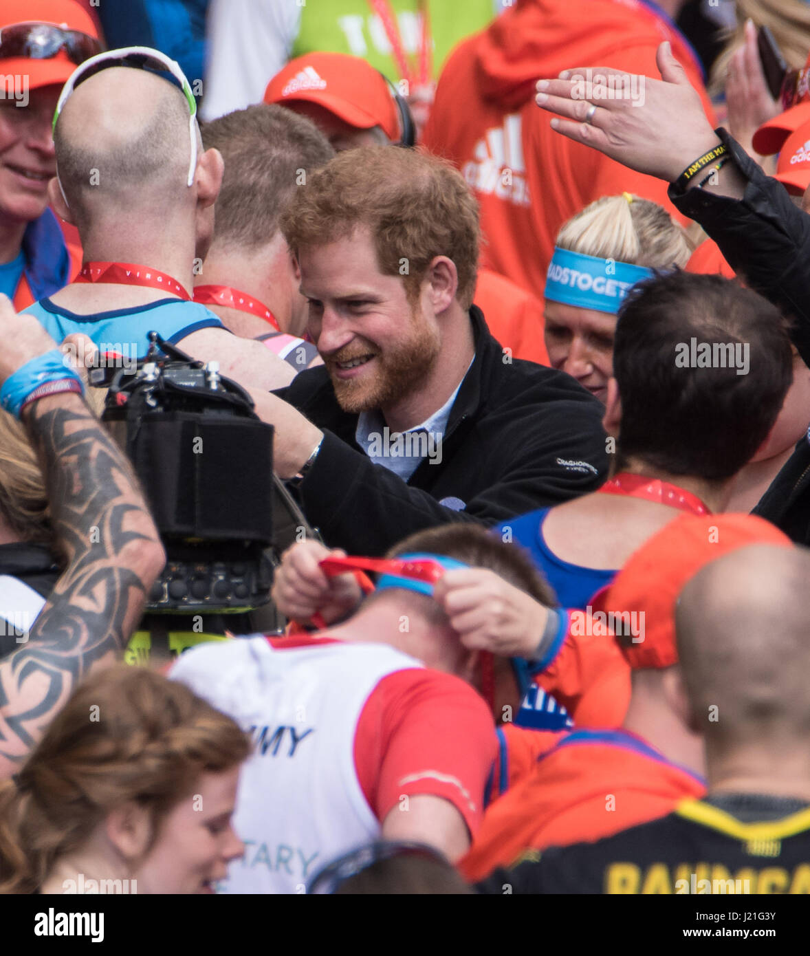 London, UK. 23rd April, 2017.HRH Prince Harry, hands out medals at the finish at the Virgin Money Marathon Credit: Ian Davidson/Alamy Live News Stock Photo