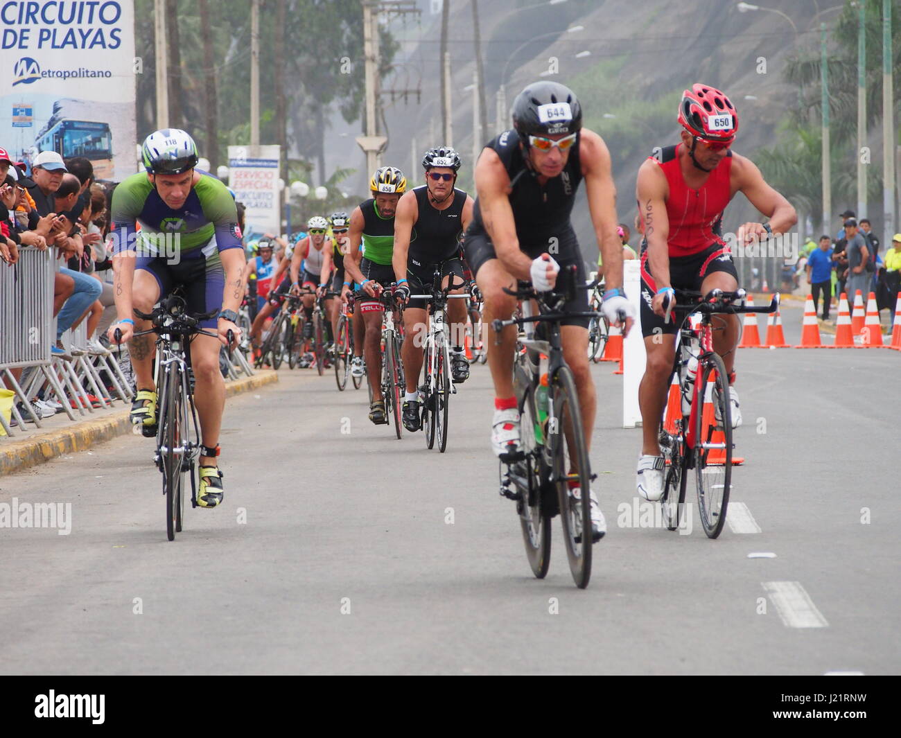Cyclists running the 90km stage. Over 1653 athletes ran in the IRONMAN 70.3 Peru race at Agua Dulce beach in Chorrillos town, Lima. Stock Photo