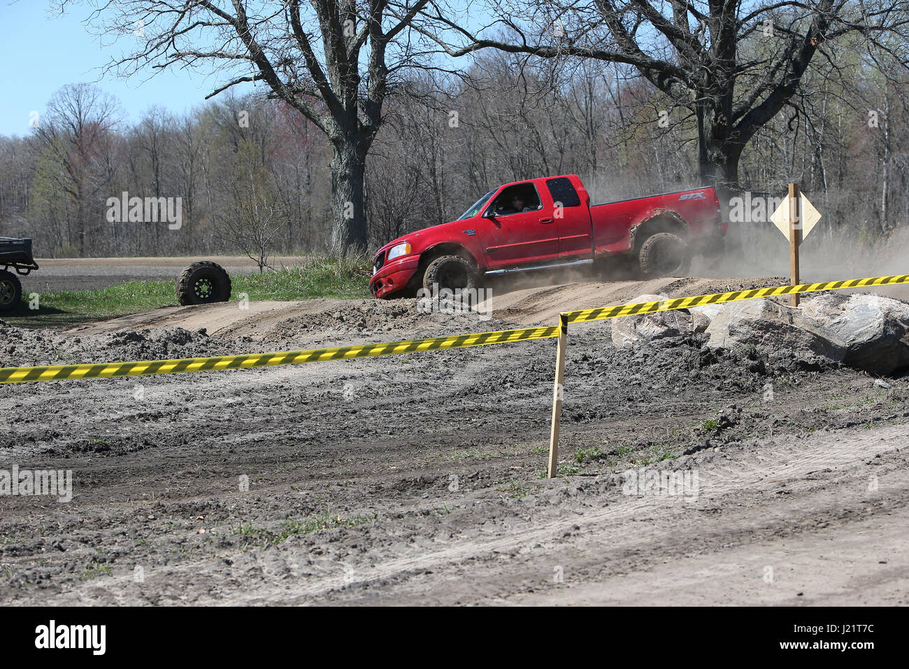 Courtland, Canada. 23rd Apr, 2017. Mud fans from all over headed to the Gopher Dunes in Norfolk Ontario today. The track consisted of 5 mud pits, 2 rock pits and a track through the forest. The high powered personal trucks made attempts to clear the mudded area. If any the trucks got stuck, there was a tractor next to the pit ready to pull them out of the mud. At the end of the day everyone went home happy even though there was blown motors, broken axels and tires that came off the trucks. Credit: Luke Durda/Alamy Live News Stock Photo