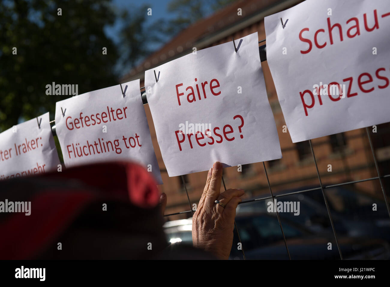 Kamenz, Germany. 24th Apr, 2017. Signs reading "fettered refugee dead", "Fair Press?" and "Show Trial" can be seen in front of the district court in Kamenz, Germany, 24 April 2017. Almost a year after the four men forced a psychologically unsound refugee from a supermarket and tied him to a tree they are now standing trial at court. The defendants between the ages of 29 abd 56 are accused of deprivation of liberty. They all plead not guilty and state that the Iraqi man posed a threat to a female cashier at the supermarket in Arnsdorf. Photo: Arno Burgi/dpa-Zentralbild/dpa/Alamy Live News Stock Photo