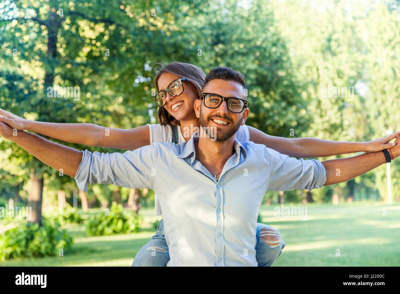 beautiful young couple having fun in the park Stock Photo - Alamy