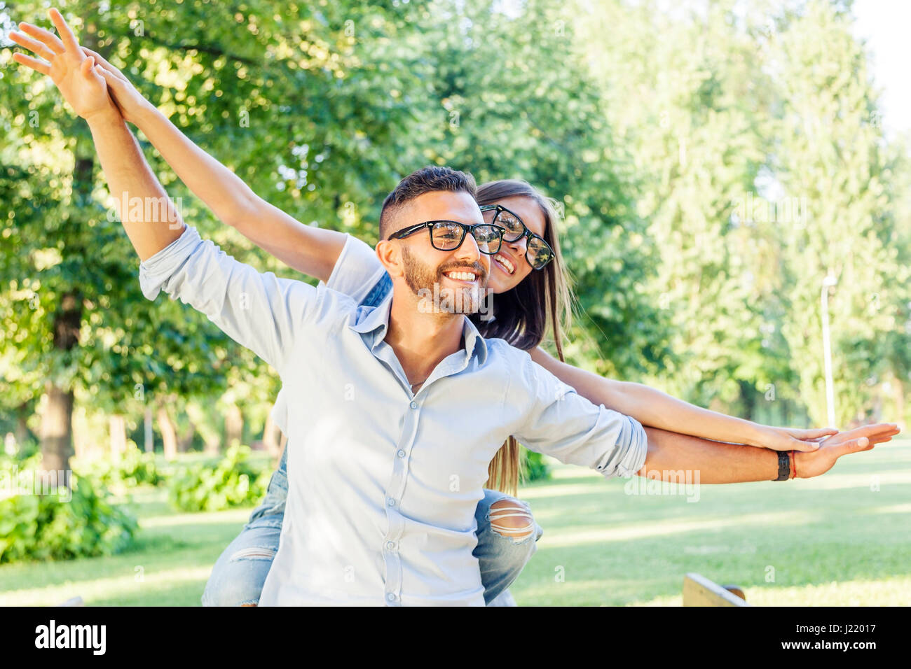 beautiful young couple having fun in the park Stock Photo - Alamy