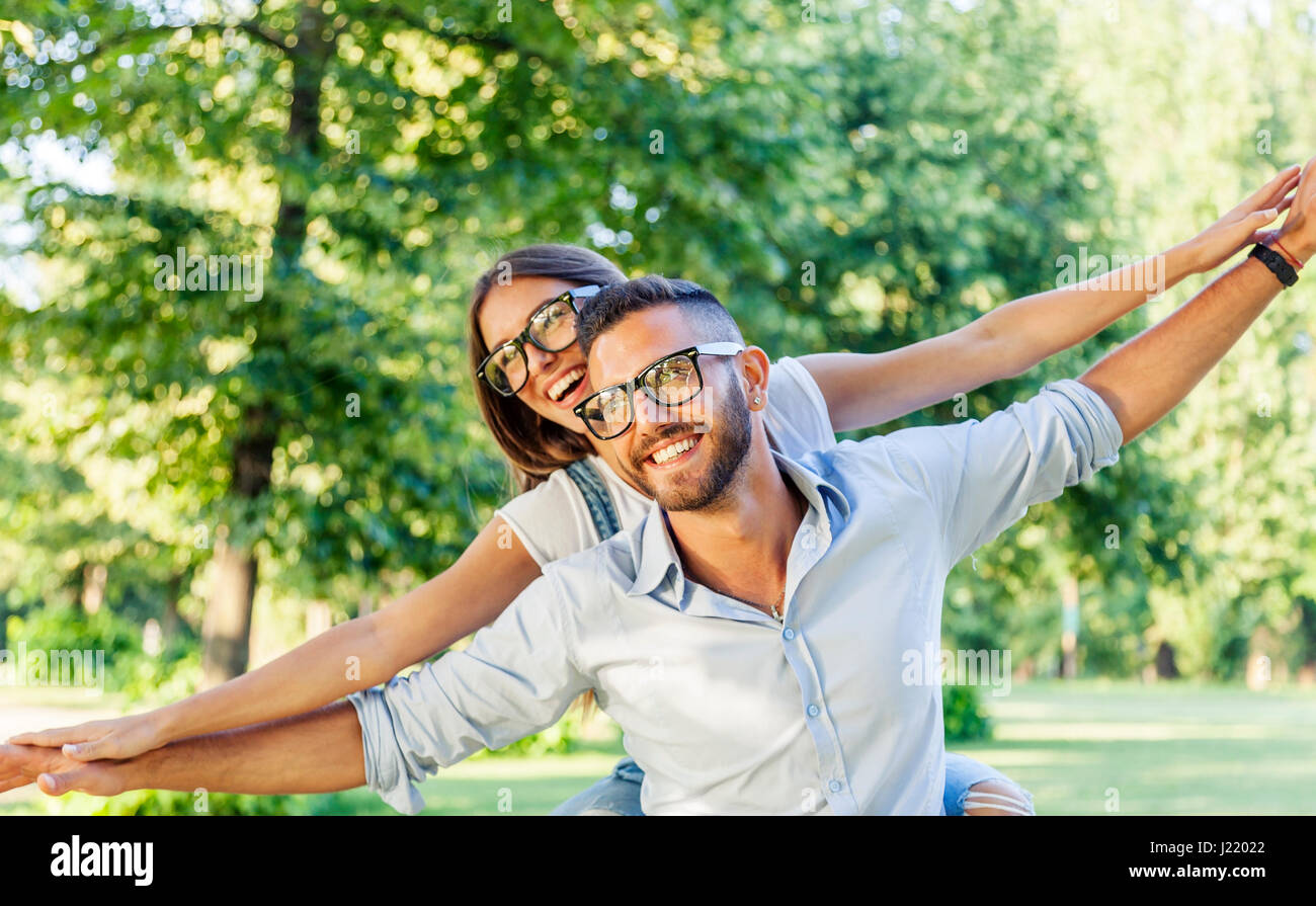 beautiful young couple having fun in the park Stock Photo - Alamy