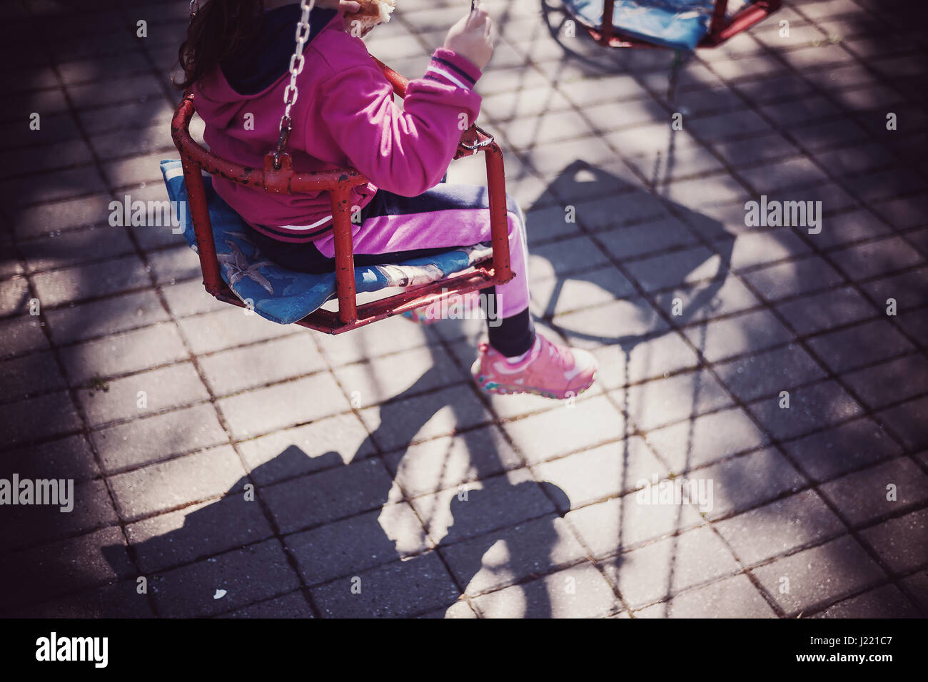 Part of a carousel for small children, little girl body part and seat. Stock Photo