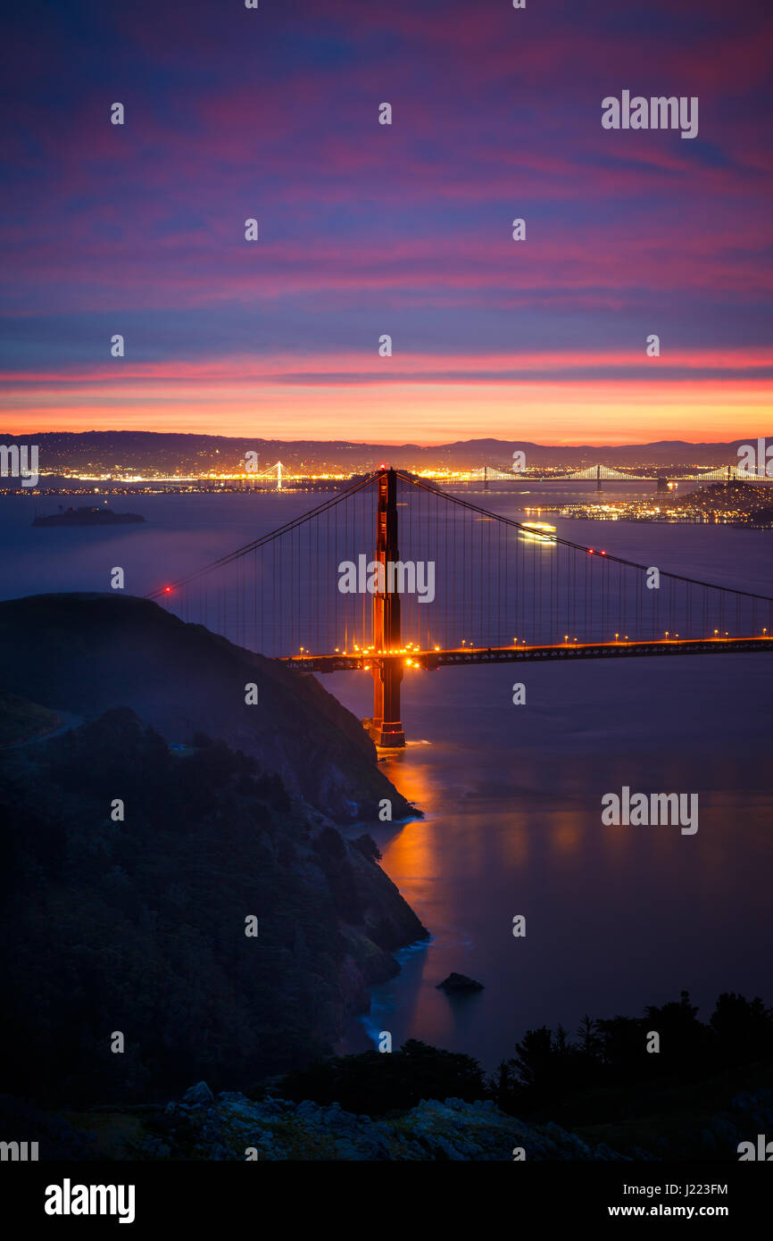 View of Golden Gate Bridge from Hawk Hill at Sunrise with Dramatic Clouds Stock Photo